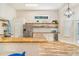 Bright kitchen featuring granite counters, stainless steel appliances, and stylish open shelving at 7838 Rollingridge Ct, Orlando, FL 32835