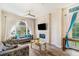 Bright living room with a stone fireplace, hardwood floors, and comfortable seating, perfect for relaxation at 7838 Rollingridge Ct, Orlando, FL 32835