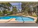 Relaxing screened-in pool with a cozy swing chair in a serene backyard setting at 7838 Rollingridge Ct, Orlando, FL 32835