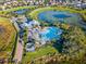 Aerial view of the community featuring a pool, clubhouse, and a scenic pond at 8057 John Hancock Dr, Winter Garden, FL 34787