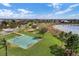 Aerial view showcases community park with play area, basketball court, and picturesque pond at 8057 John Hancock Dr, Winter Garden, FL 34787