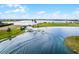 Aerial view of a lake community featuring a dock and a boat gliding through the serene waters at 8057 John Hancock Dr, Winter Garden, FL 34787