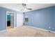 Light blue bedroom featuring a ceiling fan, window, and closet with door at 8057 John Hancock Dr, Winter Garden, FL 34787