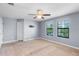 Bedroom featuring neutral carpet, light gray walls, ceiling fan and two windows at 8057 John Hancock Dr, Winter Garden, FL 34787