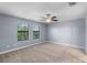 Bedroom featuring neutral carpet, light walls, a window, and a ceiling fan at 8057 John Hancock Dr, Winter Garden, FL 34787