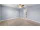 Spacious bedroom with neutral carpet, light gray walls and ceiling fan at 8057 John Hancock Dr, Winter Garden, FL 34787