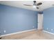 Spacious light blue bedroom with a ceiling fan and carpet flooring at 8057 John Hancock Dr, Winter Garden, FL 34787