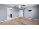 Bedroom featuring neutral carpet, light gray walls and ceiling fan at 8057 John Hancock Dr, Winter Garden, FL 34787