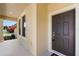 View of the front door and porch area of this house with a digital lockbox for easy showings at 8057 John Hancock Dr, Winter Garden, FL 34787