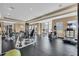 The community gym features modern exercise equipment and plenty of natural light from the windows at 8057 John Hancock Dr, Winter Garden, FL 34787