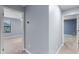 Hallway featuring neutral carpet and light walls, with entryways to bedrooms at 8057 John Hancock Dr, Winter Garden, FL 34787
