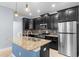 Bright kitchen featuring a center island, stainless steel appliances, and dark cabinets at 8057 John Hancock Dr, Winter Garden, FL 34787