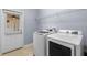 Laundry room with full size washer and dryer and access door to exterior at 8057 John Hancock Dr, Winter Garden, FL 34787