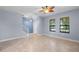 Open-plan living area, featuring tile floors, light gray walls, a decorative fan and nearby stairway at 8057 John Hancock Dr, Winter Garden, FL 34787