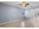 The open-concept living room features tile flooring, a ceiling fan, and natural light at 8057 John Hancock Dr, Winter Garden, FL 34787