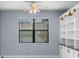 Cozy living space showcasing a window, built-in shelving with cabinet storage and sconce lighting at 8057 John Hancock Dr, Winter Garden, FL 34787
