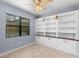 Living space featuring built-in shelving, a window for natural light and tile floors at 8057 John Hancock Dr, Winter Garden, FL 34787