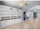 Open concept living space with large custom shelving, an airy feel and easy access to kitchen at 8057 John Hancock Dr, Winter Garden, FL 34787