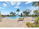 A view of the community pool area with seating and a splash fountain under a blue sky at 8057 John Hancock Dr, Winter Garden, FL 34787