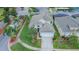 Aerial shot showcases the property with lush landscaping, a spacious driveway, and convenient street parking nearby at 8100 Fan Palm Way, Kissimmee, FL 34747