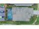Aerial view of a house with a pool, screened enclosure, well-maintained roof, and proximity to neighborhood parking spots at 8100 Fan Palm Way, Kissimmee, FL 34747