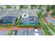 Aerial view features the home's screened-in pool, nearby parking, and close proximity to neighborhood houses at 8100 Fan Palm Way, Kissimmee, FL 34747
