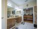 Bathroom features double sinks, granite counters, tile floors, and walk-in shower at 8100 Fan Palm Way, Kissimmee, FL 34747