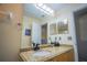 Bathroom vanity featuring granite counters and modern fixtures at 8100 Fan Palm Way, Kissimmee, FL 34747
