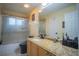 Bathroom featuring granite counters, tile shower with glass door and modern fixtures at 8100 Fan Palm Way, Kissimmee, FL 34747