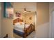 Bedroom features a decorative wooden frame bed, neutral walls, and tile flooring, complemented by colorful artwork at 8100 Fan Palm Way, Kissimmee, FL 34747