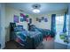 Bright bedroom featuring two beds, carpet floors, and overhead lighting at 8100 Fan Palm Way, Kissimmee, FL 34747