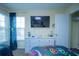 Bedroom featuring entertainment center, carpet floors, and bright window at 8100 Fan Palm Way, Kissimmee, FL 34747