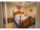 This bedroom features a decorative wood bed frame, tile floors, a ceiling fan, and colorful dog themed art at 8100 Fan Palm Way, Kissimmee, FL 34747