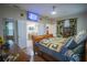 A bedroom featuring wood floors, ceiling fan, a TV and stylish decor and connecting bath at 8100 Fan Palm Way, Kissimmee, FL 34747