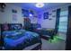 Bedroom featuring two beds, gaming theme, and carpet floors at 8100 Fan Palm Way, Kissimmee, FL 34747