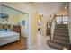 A spacious entryway with tiled flooring, an archway, and views into the living room and bedroom at 8100 Fan Palm Way, Kissimmee, FL 34747