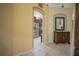 Hallway with a brown wood dresser and views into the kitchen and living areas at 8100 Fan Palm Way, Kissimmee, FL 34747