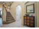 Hallway with tiled floors, a brown wood dresser, a white door, and a carpeted stairway at 8100 Fan Palm Way, Kissimmee, FL 34747