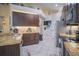 Well-lit kitchen with stainless steel appliances, granite counters, and brown cabinets at 8100 Fan Palm Way, Kissimmee, FL 34747