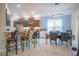Open kitchen with granite countertop bar, stainless appliances, and adjacent dining area at 8100 Fan Palm Way, Kissimmee, FL 34747