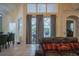 Living room with patio door and a view of the screened-in pool at 8100 Fan Palm Way, Kissimmee, FL 34747