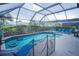 Relax by the pool in a screened enclosure with many lounge chairs and mature landscaping at 8100 Fan Palm Way, Kissimmee, FL 34747
