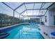 Enjoy this private screened-in pool and patio area with lots of lounge chairs at 8100 Fan Palm Way, Kissimmee, FL 34747