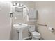 Cozy half bathroom with pedestal sink, toilet, and a wall-mounted cabinet at 9014 Great Sound Dr, Orlando, FL 32827