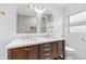 Bathroom vanity with double sinks, arched mirrors, and white countertop at 9014 Great Sound Dr, Orlando, FL 32827