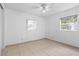 Bedroom featuring tile flooring, a ceiling fan, and two windows with blinds at 9014 Great Sound Dr, Orlando, FL 32827
