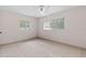 Bright bedroom with tile flooring, a ceiling fan, and natural light from two windows at 9014 Great Sound Dr, Orlando, FL 32827