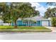 Charming blue single Gathering home with a well manicured front lawn and mature trees at 9014 Great Sound Dr, Orlando, FL 32827