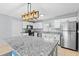 Modern kitchen includes white cabinets, stainless steel appliances, and a stylish island at 9014 Great Sound Dr, Orlando, FL 32827