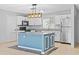 Modern kitchen includes white cabinets, stainless steel appliances, and a stylish island at 9014 Great Sound Dr, Orlando, FL 32827